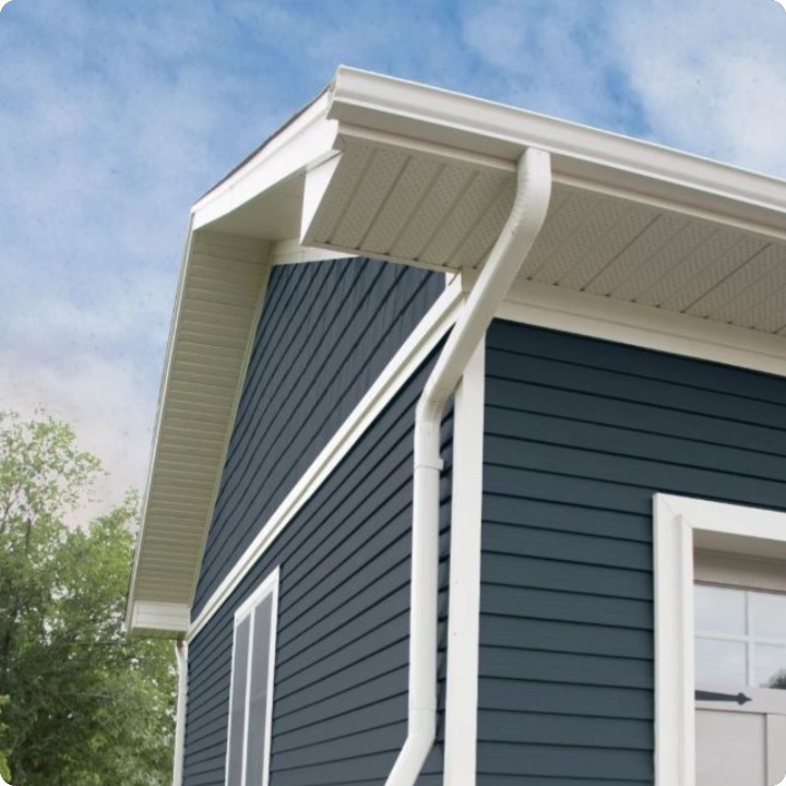 Navy blue lap siding with crisp white gutters and trim